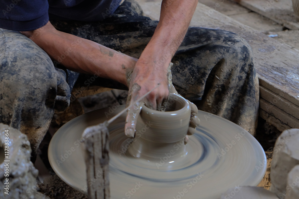 Hands Making Pottery On A Wheel