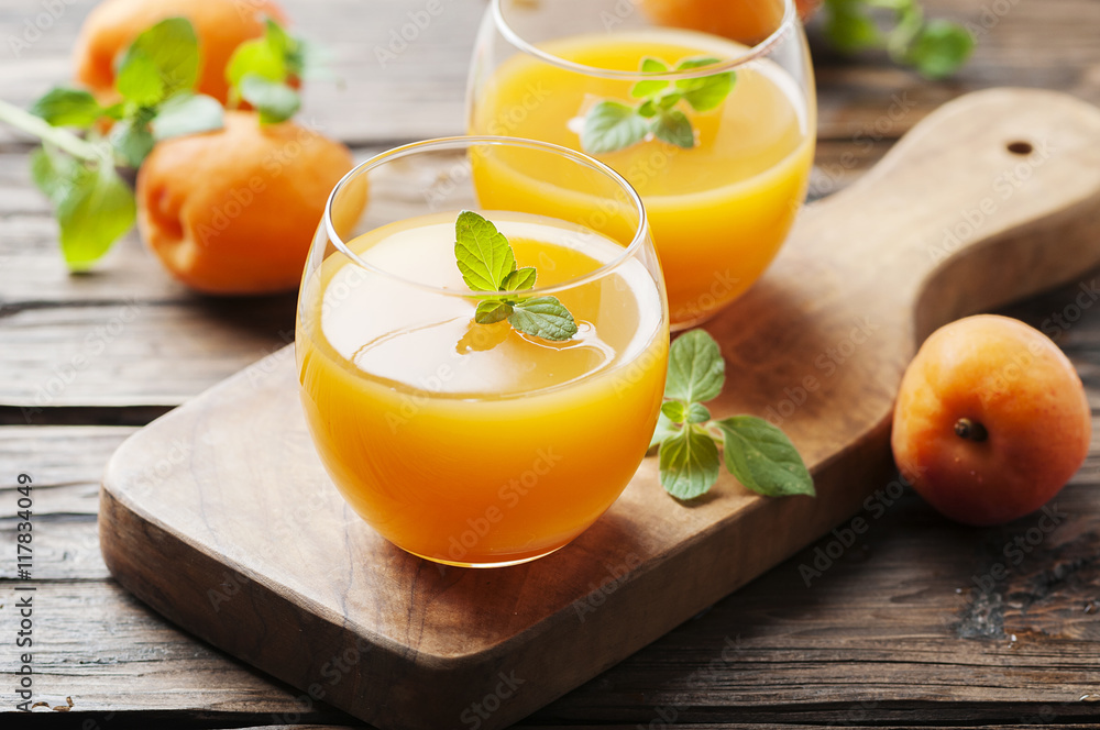 Healthy apricot juice with mint on the wooden table Healthy apricot juice with mint on the wooden table