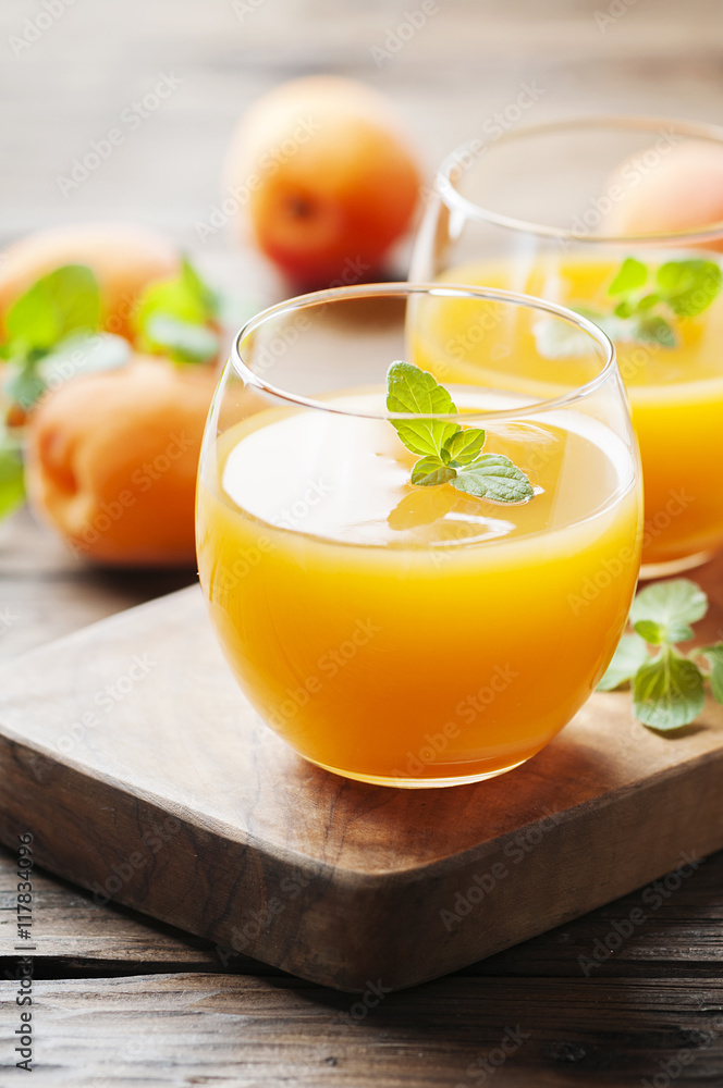 Healthy apricot juice with mint on the wooden table Healthy apricot juice with mint on the wooden table