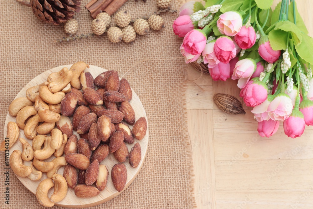 Almonds and cashew is delicious on wood background. Almonds and cashew is delicious on wood background.