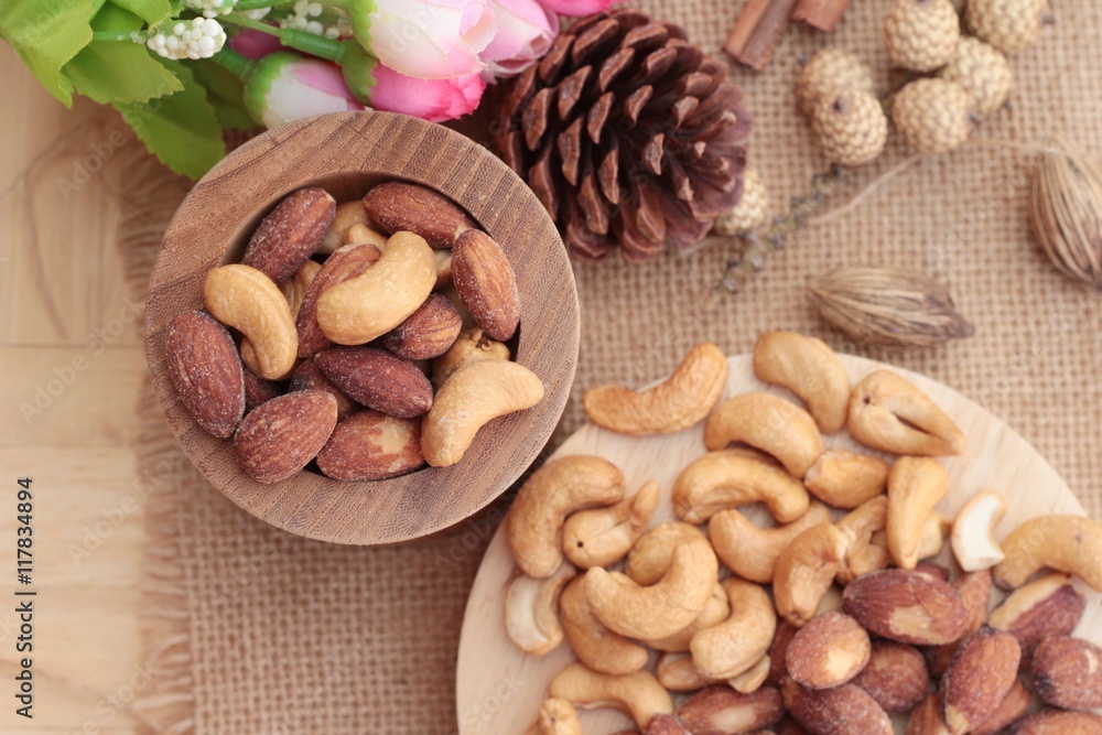 Almonds and cashew is delicious on wood background. Almonds and cashew is delicious on wood background.
