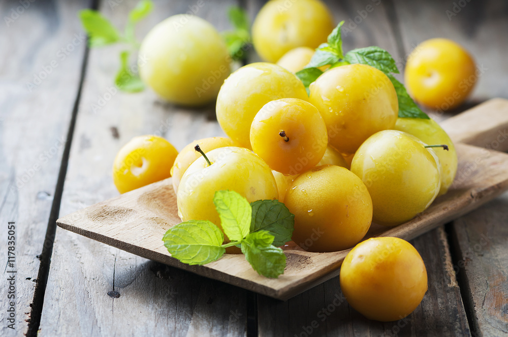 Summer sweet yellow plums on the wooden table Summer sweet yellow plums on the wooden table