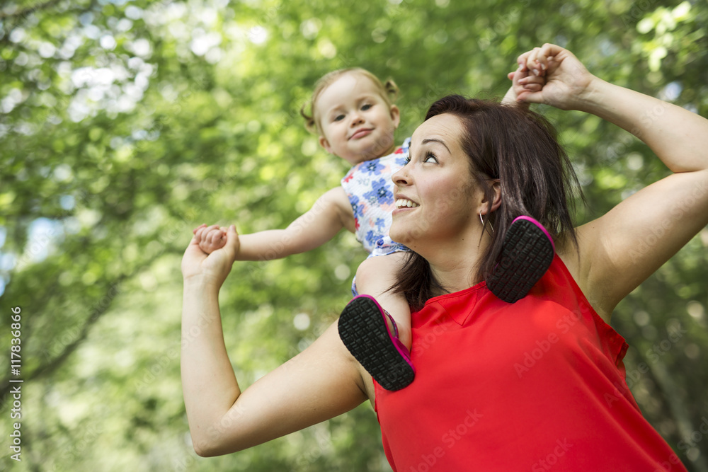 Fototapeta premium Mother and daughter in forest having fun
