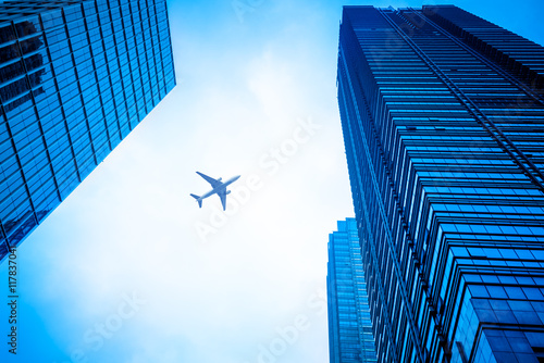 looking up flying plane,blue toned image,china.