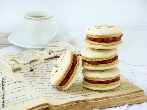 cup of espresso coffee and French macaroons dessert on light background