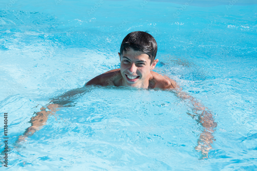Closeup of the young man relaxing in the pool