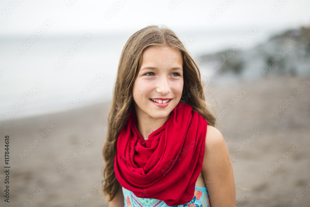 Girl enjoying the rain and having fun outside on the beach a gray rainy Girl enjoying the rain and having fun outside on the beach a gray rainy