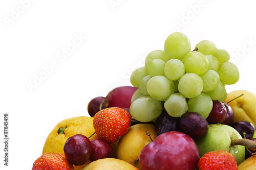 Mix fruit and berries isolated on a white background. Assorted strawberries and grapes  apples and oranges. Healthy fruits for diet rich in vitamins. Food for vegetarians.
