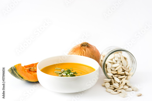 Pumpkin soup and ingredients isolated on white background

