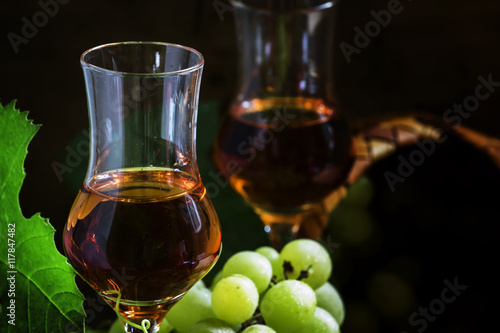 Yellow grappa, Italian vodka in traditional shot glasses, dark v
