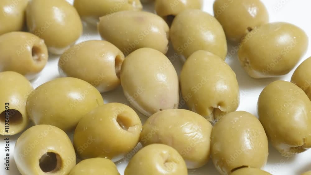 Marinated green European table olives served on the plate slow tilt 4K 2160p 30fps UltraHD video - Oleae europaea tasty ripe fruit tilting 4K 3840X2160 UHD footage Marinated green European table olives served on the plate slow tilt 4K 2160p 30fps UltraHD video - Oleae europaea tasty ripe fruit tilting 4K 3840X2160 UHD footage