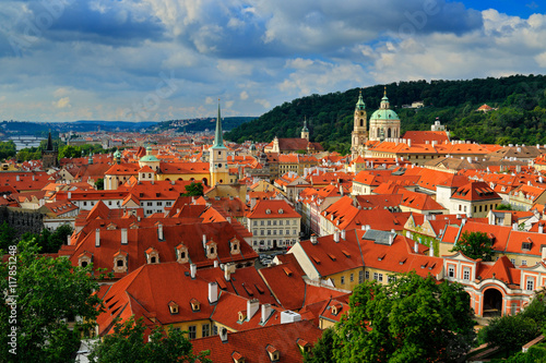 Red roofs in the city Prague. Panoramic view of Prague from the Prague Castle, Czech Republic. Summer day with blue sky with clouds in the town. Many roofs in the beautiful town Praha, Europe
