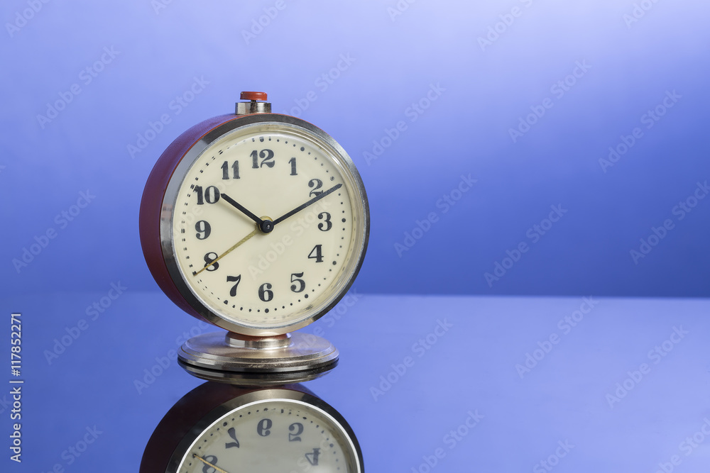 retro clock on nice blue background with reflection retro clock on nice blue background with reflection