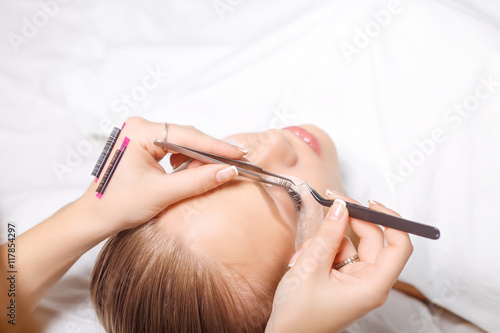 Eyelash Extension Procedure. Woman Eye with Long Eyelashes. Lashes, close up, selected focus.