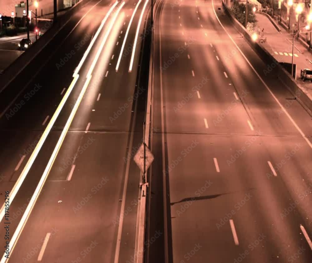 Timelapse of Traffic on a United States highway at night showing light streaks, sepia tone.
Timelapse of Traffic on a United States highway at night showing light streaks, sepia tone.