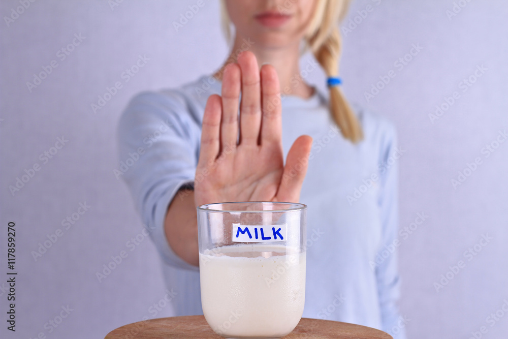 Lactose intolerance. Dairy Intolerant Woman refuses to drink milk Stock