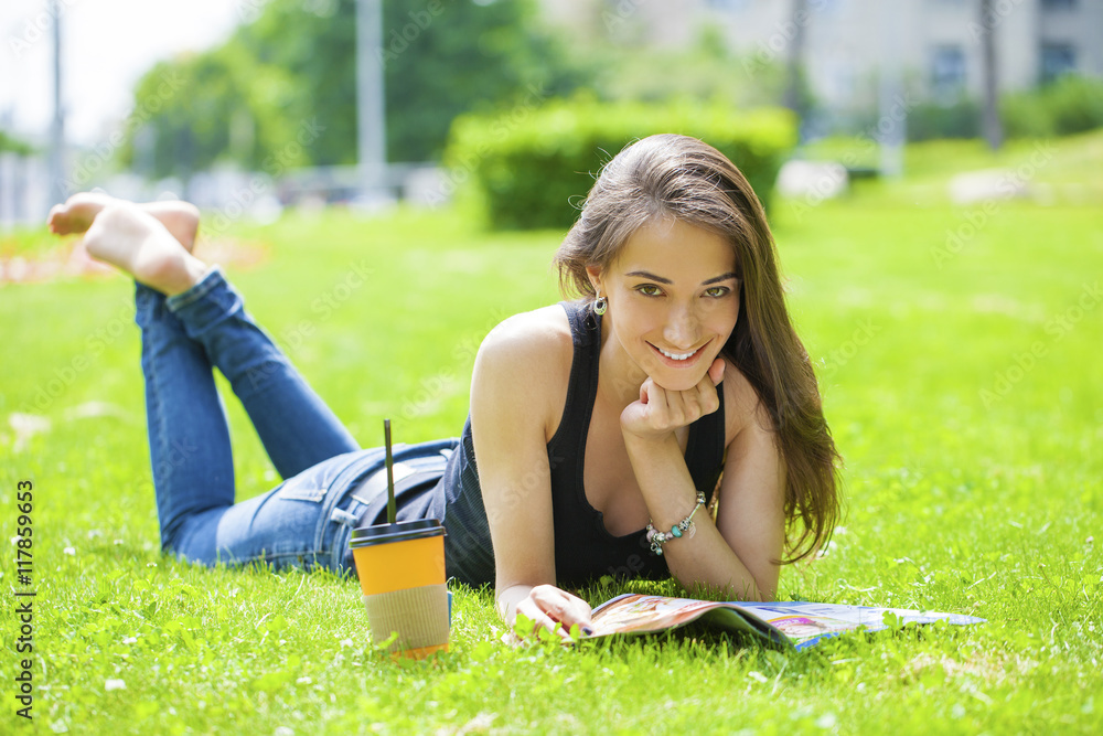 Young beautiful woman sitting in the summer park Young beautiful woman sitting in the summer park