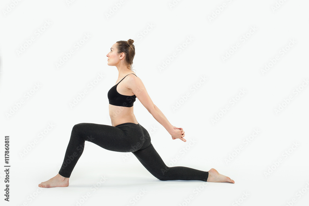 Young brunette woman doing pilates exercises isolated Young brunette woman doing pilates exercises isolated
