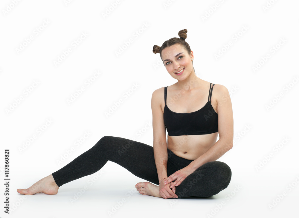 Young brunette woman doing pilates exercises isolated Young brunette woman doing pilates exercises isolated