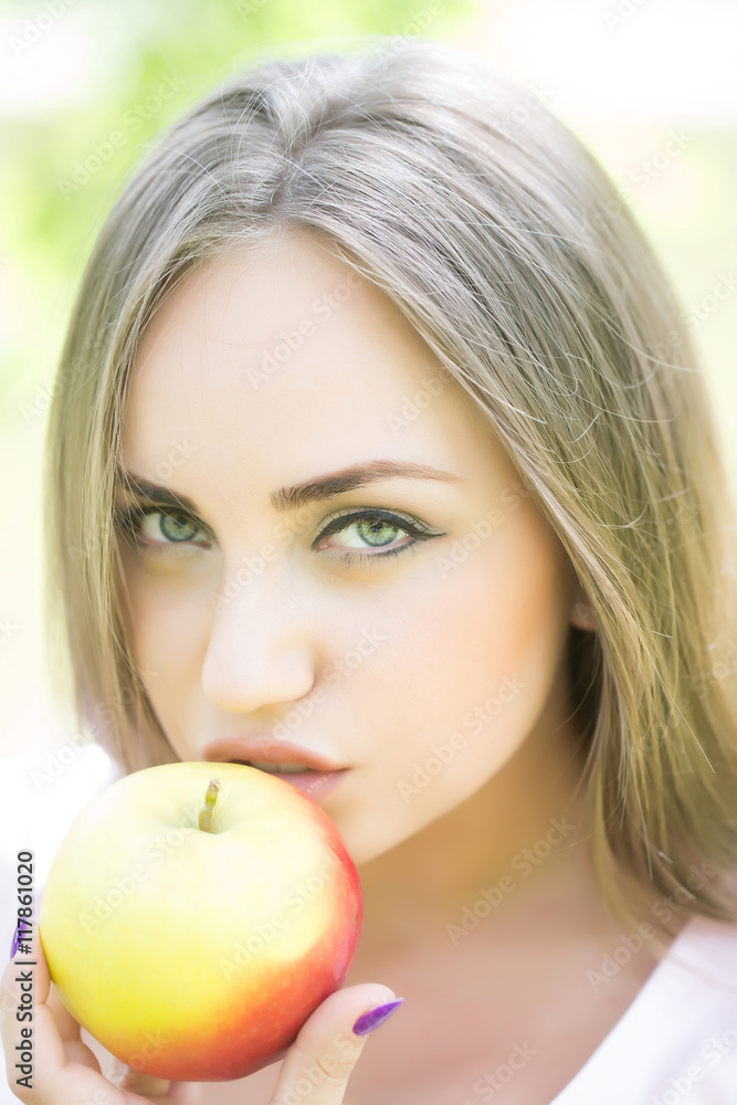 Young beautiful woman eats apple Young beautiful woman eats apple