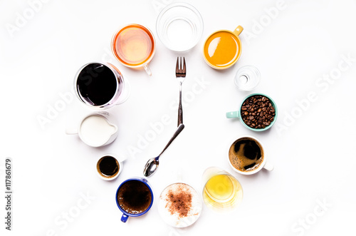 Cups with liquids like a coffee, milk, wine, alcohol, juice stacked in a circle. Clock consist of twelve cups. Time. Alarm clock. Beverages.