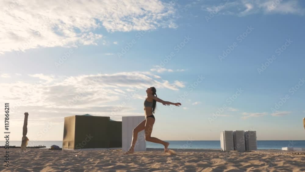 Young girl spiking volleyball on the beach, slow motion Young girl spiking volleyball on the beach, slow motion