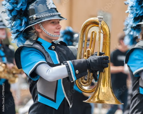 Teen baritone player marching in the band.  photo