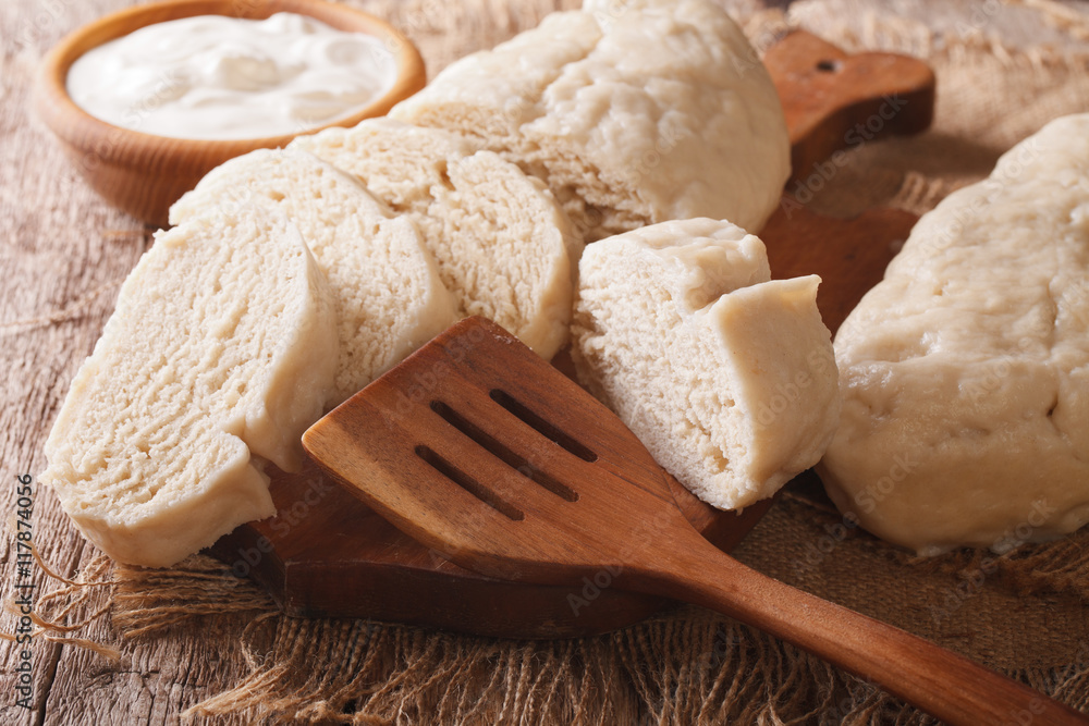 Fresh sliced yeast knedliks and sour cream close-up. horizontal
Fresh sliced yeast knedliks and sour cream close-up. horizontal