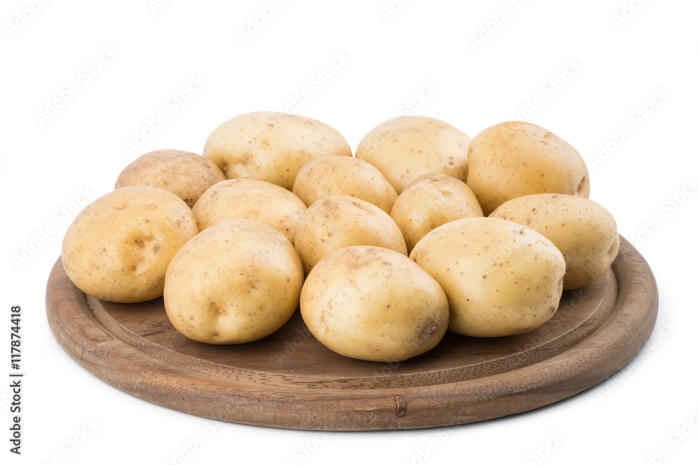 Young potatoes on a cutting board on white background close-up. Young potatoes on a cutting board on white background close-up.