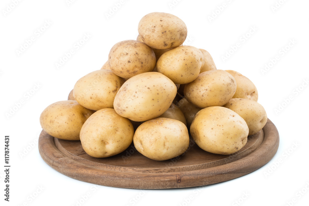 Young potatoes on a cutting board on white background close-up. Young potatoes on a cutting board on white background close-up.