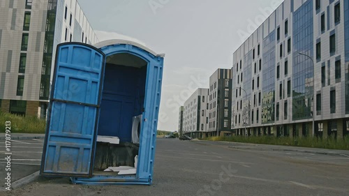 Blue public toilet at empty street of innopolis city, close up photo