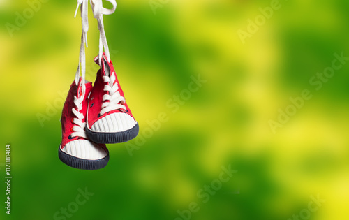 Sport baby shoes hanging on the rope
