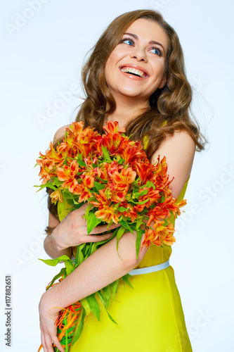 Smiling happy woman with flowers looking side.