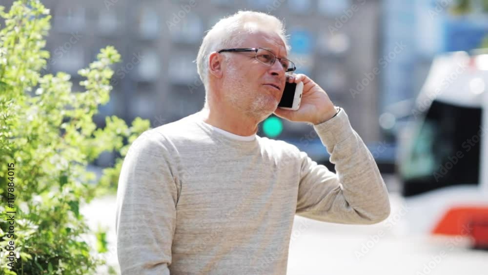 senior man calling on smartphone in city senior man calling on smartphone in city