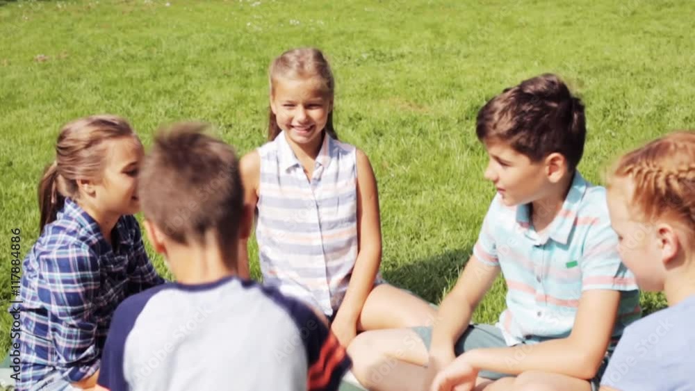 group of happy kids making high five outdoors group of happy kids making high five outdoors
