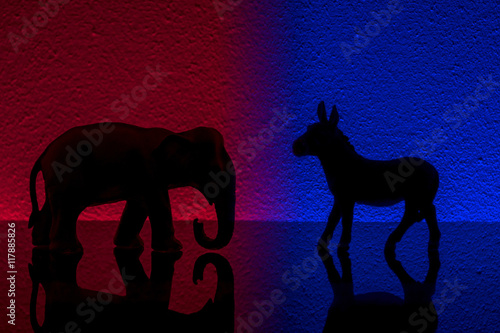 Fotografie Democrats vs republicans are facing off in a ideological duel on blue and red backgrounds