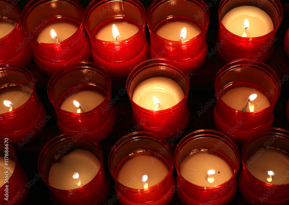 series of candles lit inside the place of worship to pray series of candles lit inside the place of worship to pray