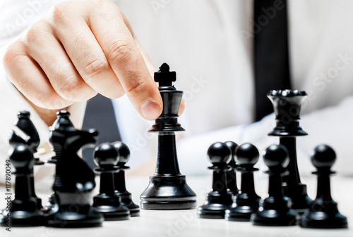 Hand of businessman playing chess