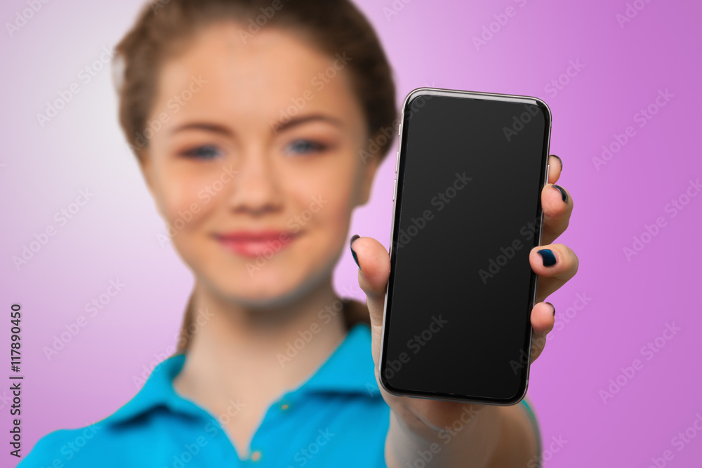 Smiling young woman showing blank smartphone screen Smiling young woman showing blank smartphone screen