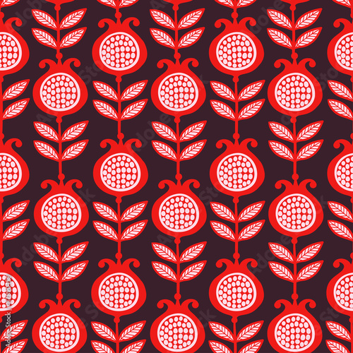 Vector seamless illustration of pomegranates. Bright garnet red with white grains on a dark background. Pattern.