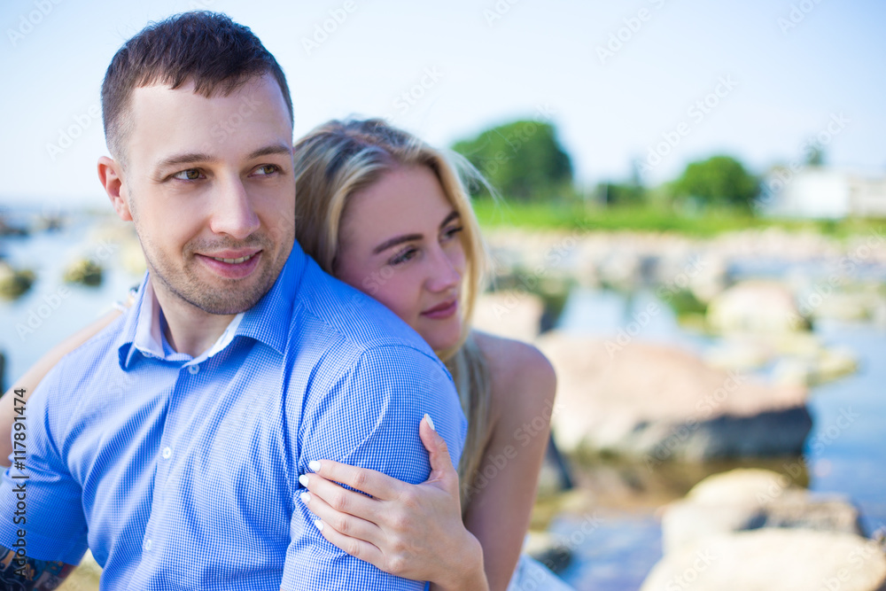 portrait of beautiful couple in love on rocky beach portrait of beautiful couple in love on rocky beach