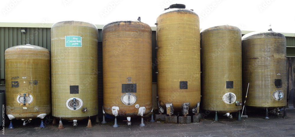 Row of fermentation vessels in cider brewery Row of fermentation vessels in cider brewery