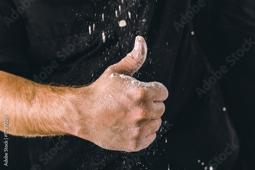adult man hands work with flour  dark photo