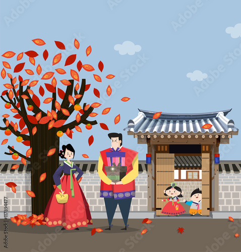 A couple dressed in Korean traditional costume and traditional Korean style house