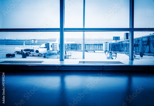 Airplanes On Airport Runway Seen Through Glass Window