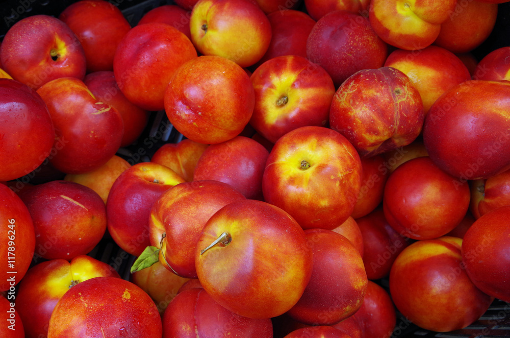 Nectarines with yellow center piled for market close up view Nectarines with yellow center piled for market close up view