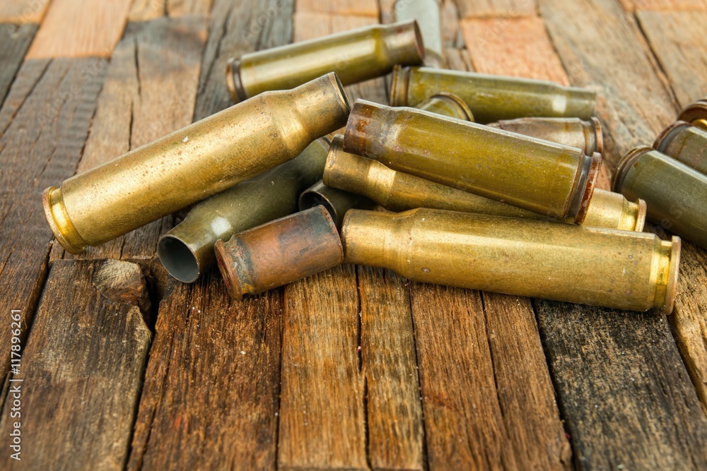 Bullets shell on wooden background.  Stock image macro.