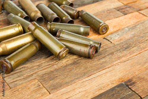 Bullets shell on wooden background. Stock image macro.
