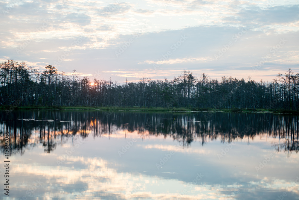 Fototapeta premium reflections in the lake water at sunrise