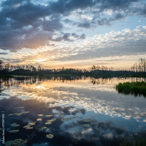 reflections in the lake water at sunrise